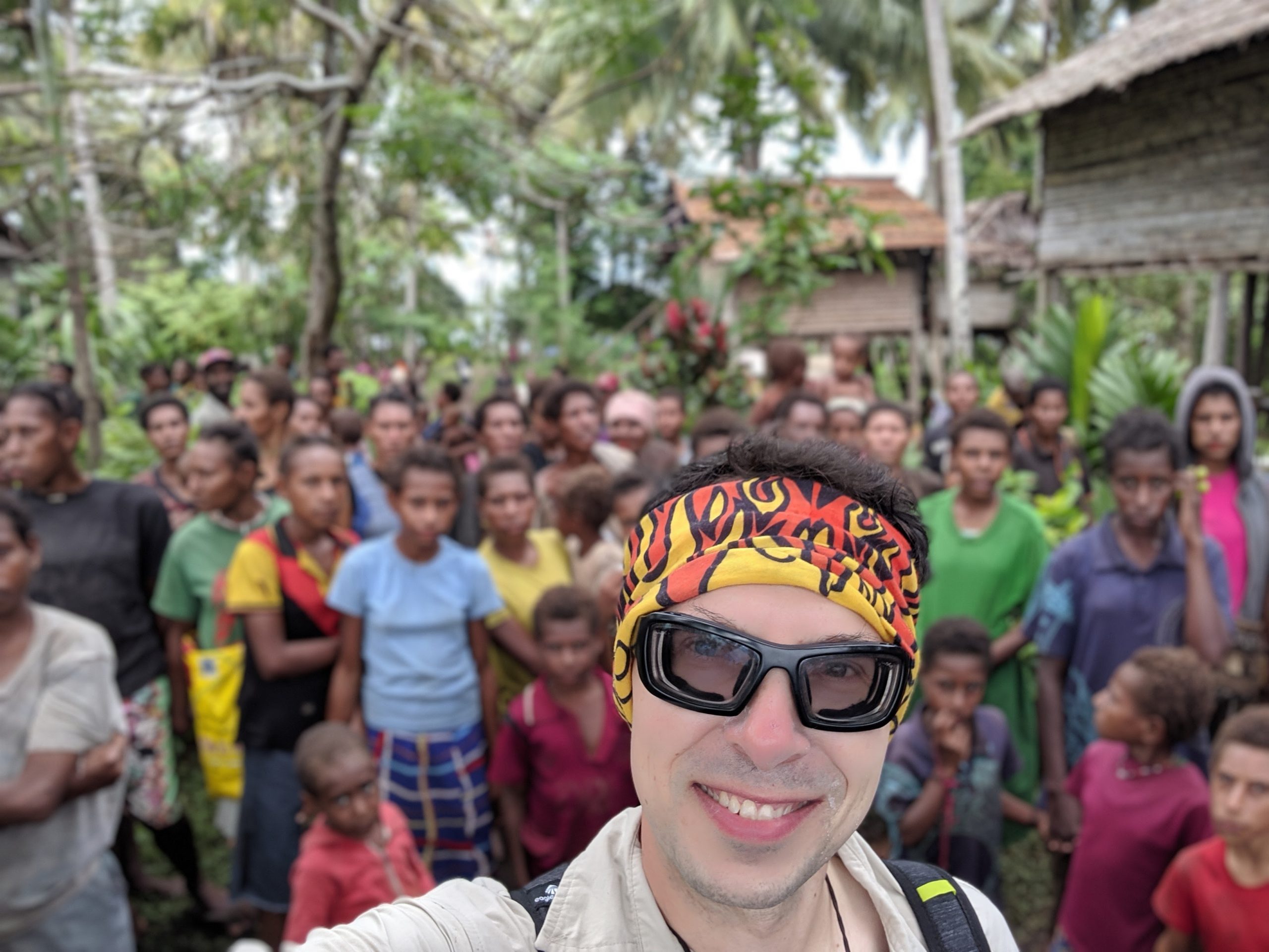 Profile photo of Adam the Adventurer with a background of a tribe of people from Papua New Guinea