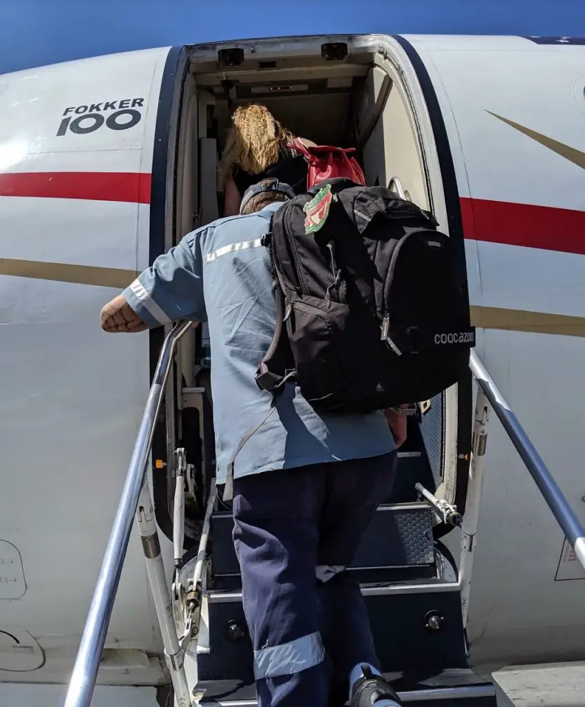 climbing into a small airplane