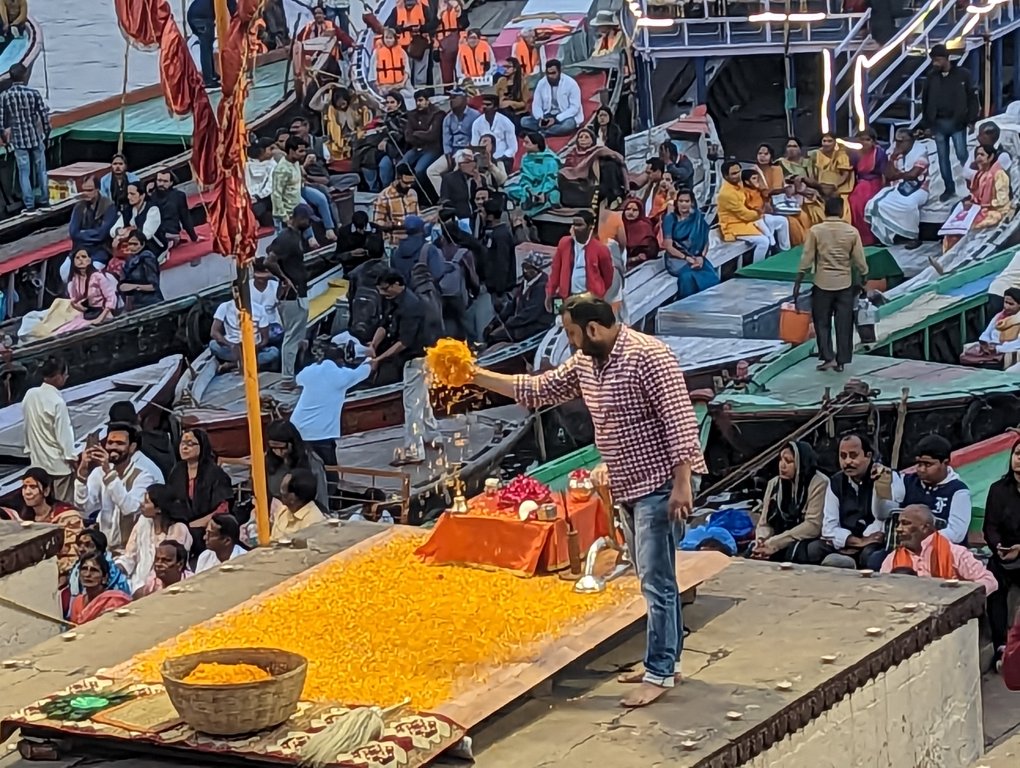 Person setting up the venue for evening prayer Varanasi, the Ganges River