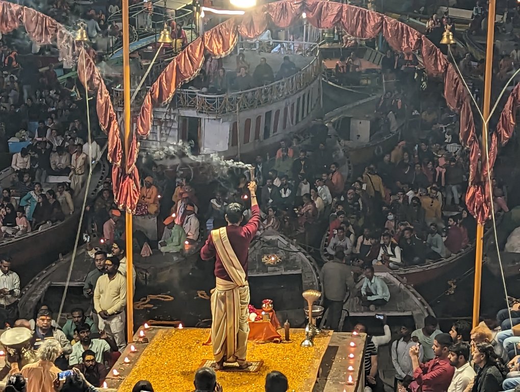 Priest with incense at evening prayer in Varanasi, the Ganges River